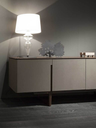 Fidelio low cabinet placed in a living space with a table lamp on top, highlighting its horizontal form and use as a side storage unit