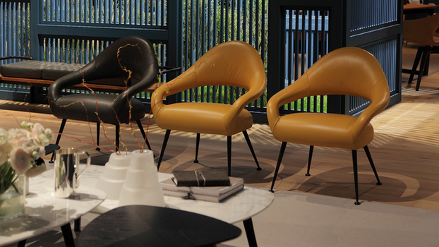 Letizia Armchair by Poltrona Frau designed by Gastone Rinaldi from the Letizia collection styled around a contemporary table highlighting the sculptural upholstered armchair for refined interiors