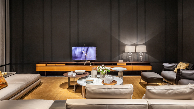 Fidelio multimedia cabinet by Poltrona Frau designed by Roberto Lazzeroni styled within a contemporary living room interior highlighting the refined media storage unit