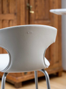 Rear view detail of the Montera Mas stool by Poltrona Frau highlighting the curved backrest and stitching
