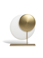 Standalone Moonbeam table lamp with a circular light disc and horizontal base, presented to emphasise its sculptural and minimal design