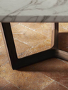Close-up of the Bolero Ravel table base showing the angular structure and intersecting supports with precise joinery and architectural form