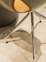 Close-up of the chair’s four-spoke base showing the structure of the legs and connection to the seat