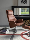 Downtown lounge armchair by Poltrona Frau shown in a reclined position emphasizing relaxation and support