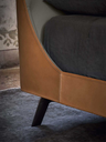 Close-up of the Mamy Blue bed showing the transition between the upholstered frame and the inner panel