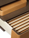 Close-up of the cabinet top showing the integrated tray surface and slatted detailing designed for media equipment organisation