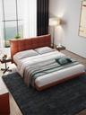Aurora Tre bed styled with layered bedding and bedside elements, highlighting its upholstered headboard and inviting form