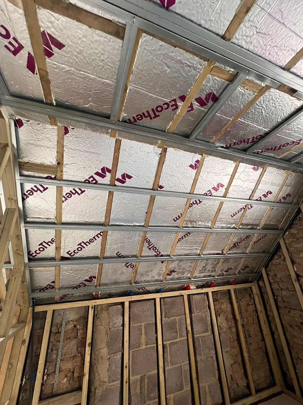 Wooden framework with insulation on ceiling.