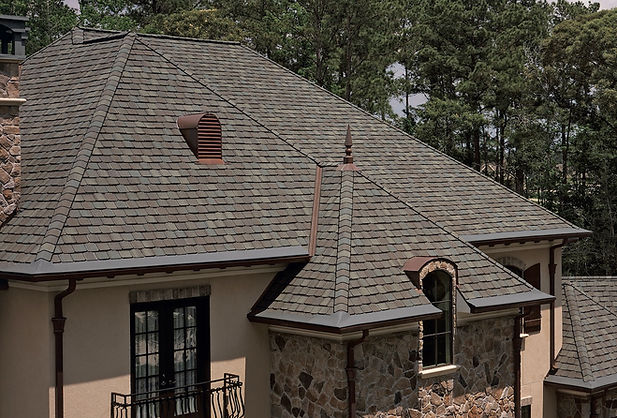 House exterior with a shingle roof and windows
