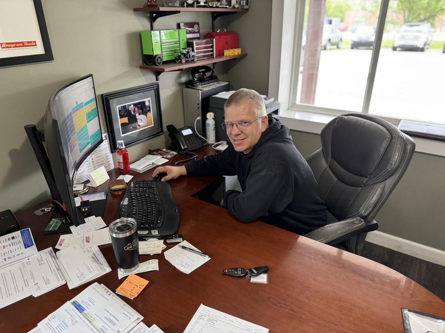 Man smiling at desk with computer