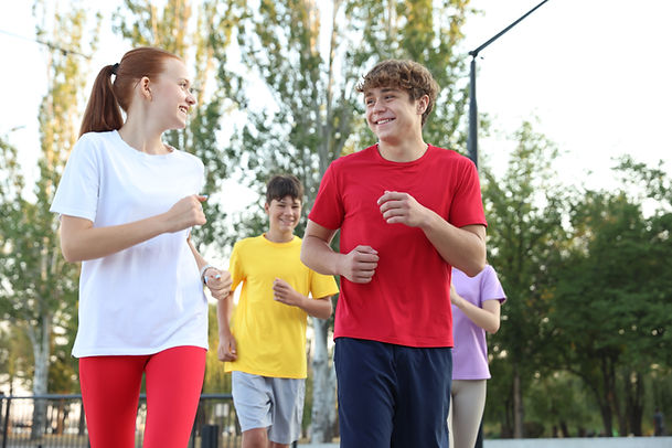 Group of teenagers jogging outdoors Morning run.jpg