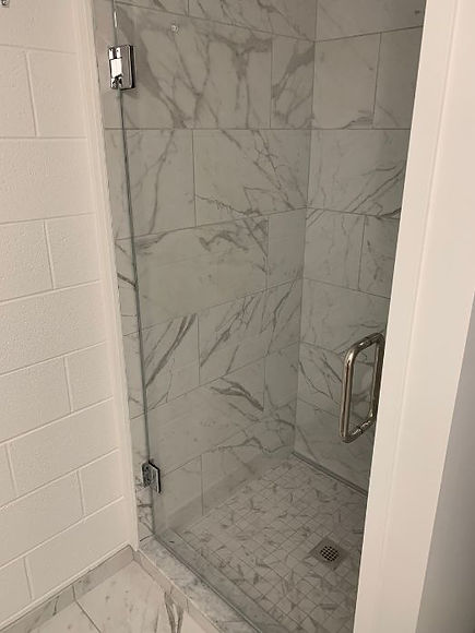 mps installed modern shower with a glass door and porcelain tiles.