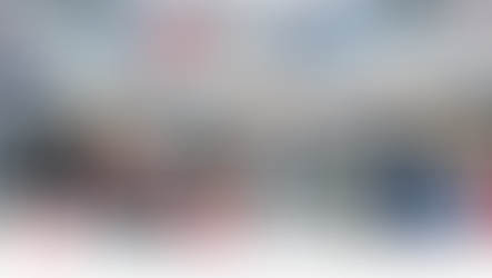 People browse shoe materials and machinery at a trade fair. Booths display leather samples, shoes; colorful backdrop, busy atmosphere.