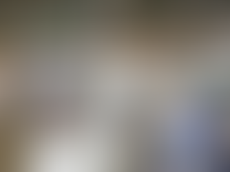 Busy trade show with numerous booths in a large hall. Signs include "KOREA METAL WEEK." Visitors explore displays under bright lights.