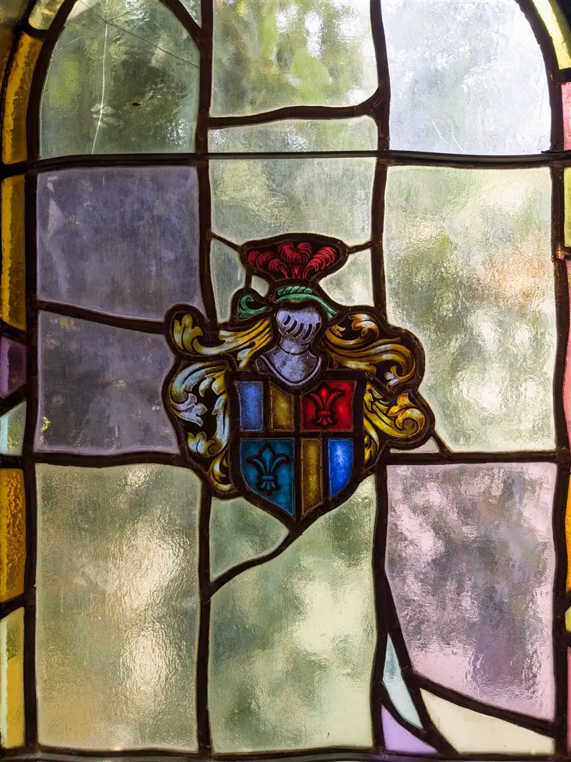 Heraldic stained glass window in the central stair at 1239 Geneva Street