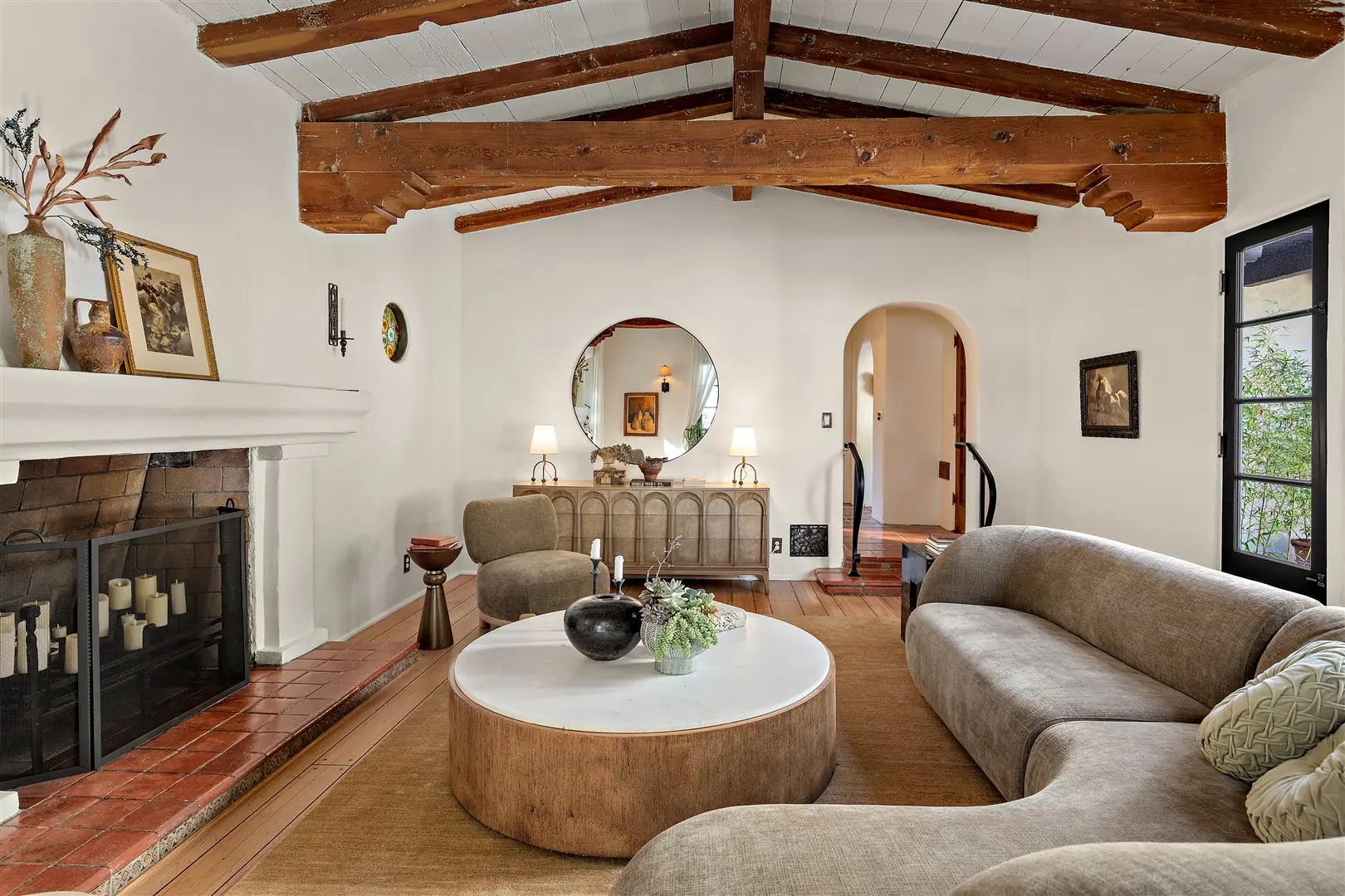 Living room with restored hardwood floors, plaster walls, and exposed beams at 1239 Geneva Street