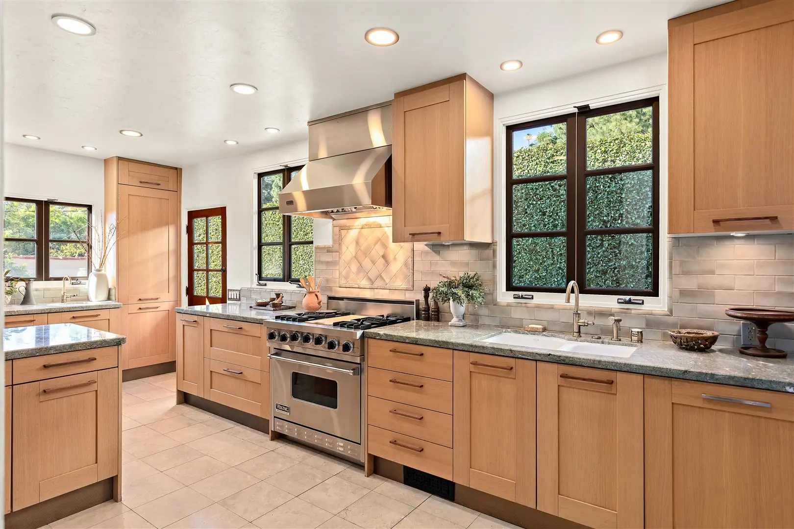 Kitchen with Greek Villa walls and restored dark-framed windows at 1239 Geneva Street