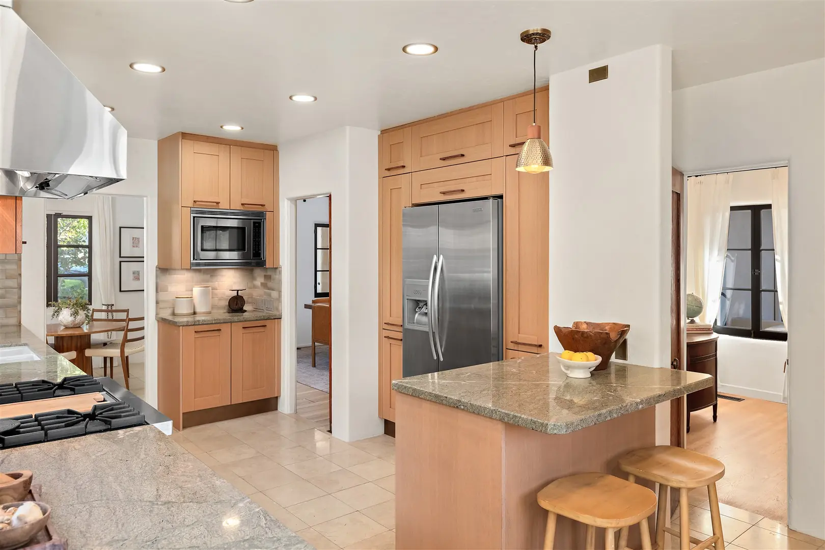 Kitchen cabinetry, stone surfaces, and restored windows at 1239 Geneva Street