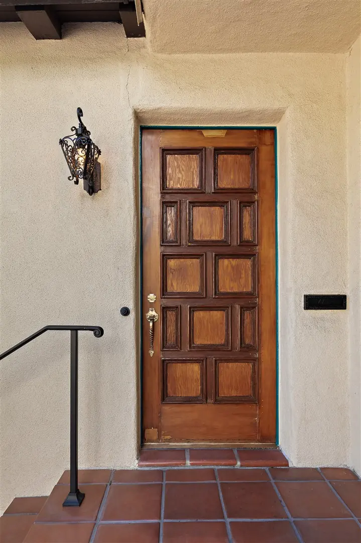 Restored original wood entry door with period hardware at 1239 Geneva Street