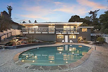 Exterior of an El Cerrito Mid-Century view home with pool infrastructure at dusk - Market Intelligence by Colin Davies.
