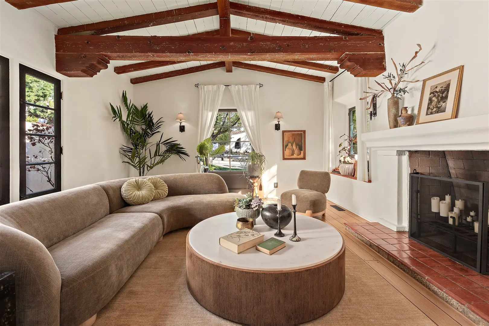 Living room with restored hardwood floors, plaster walls, and exposed beams at 1239 Geneva Street
