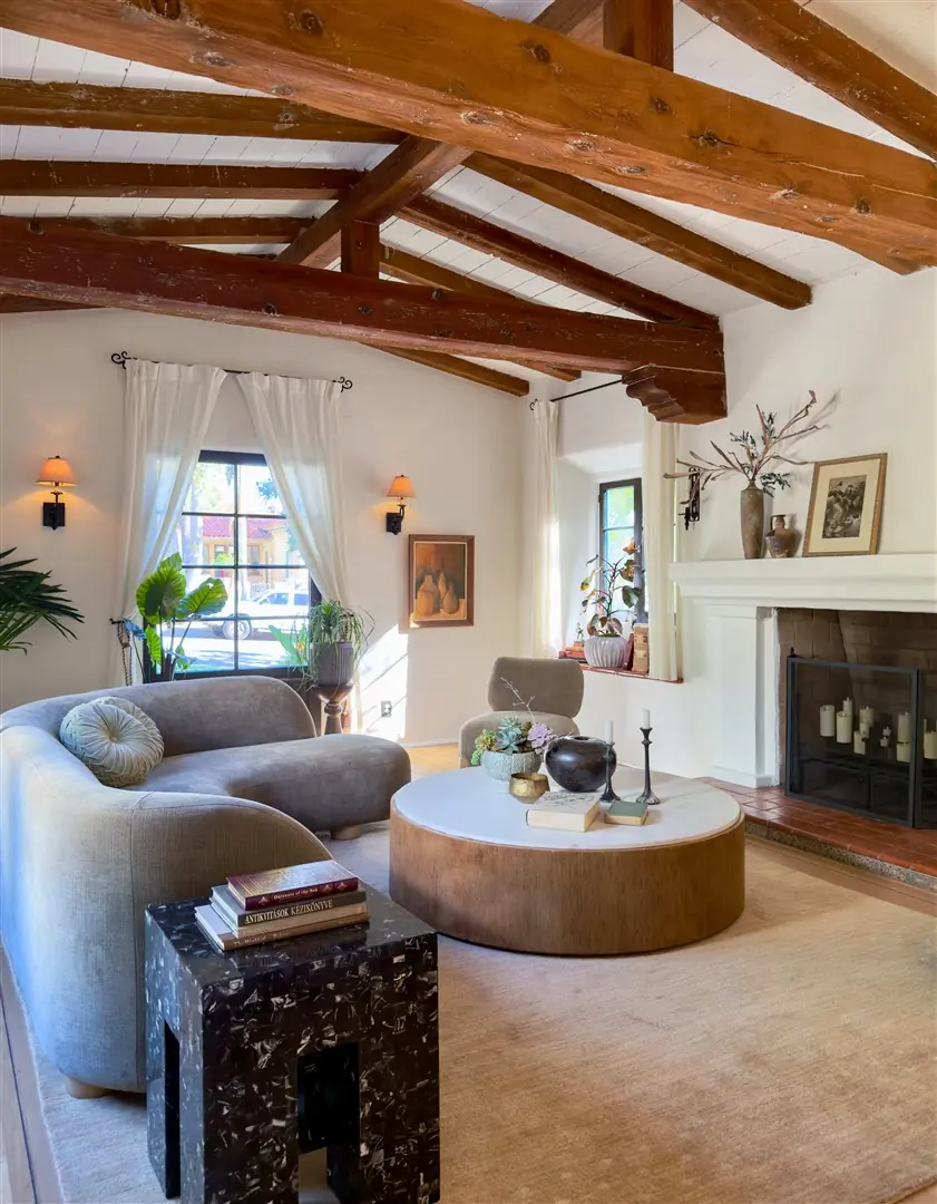 Living room with restored hardwood floors, plaster walls, and exposed beams at 1239 Geneva Street