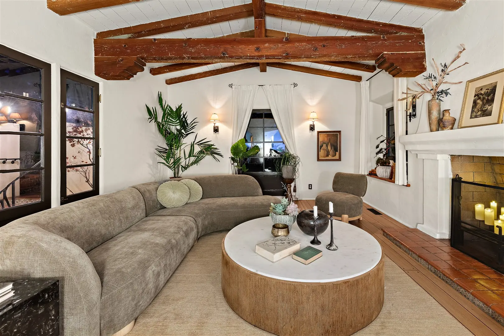 Living room with restored hardwood floors, plaster walls, and exposed beams at 1239 Geneva Street