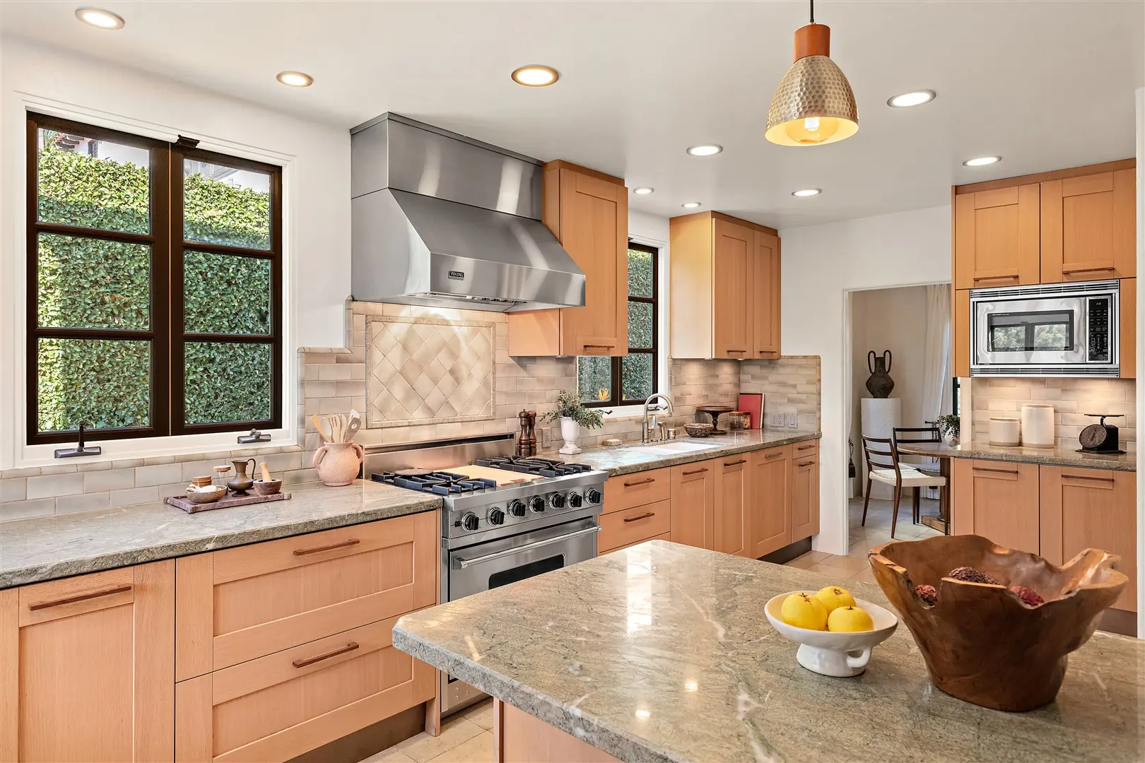 Kitchen cabinetry, stone surfaces, and restored windows at 1239 Geneva Street
