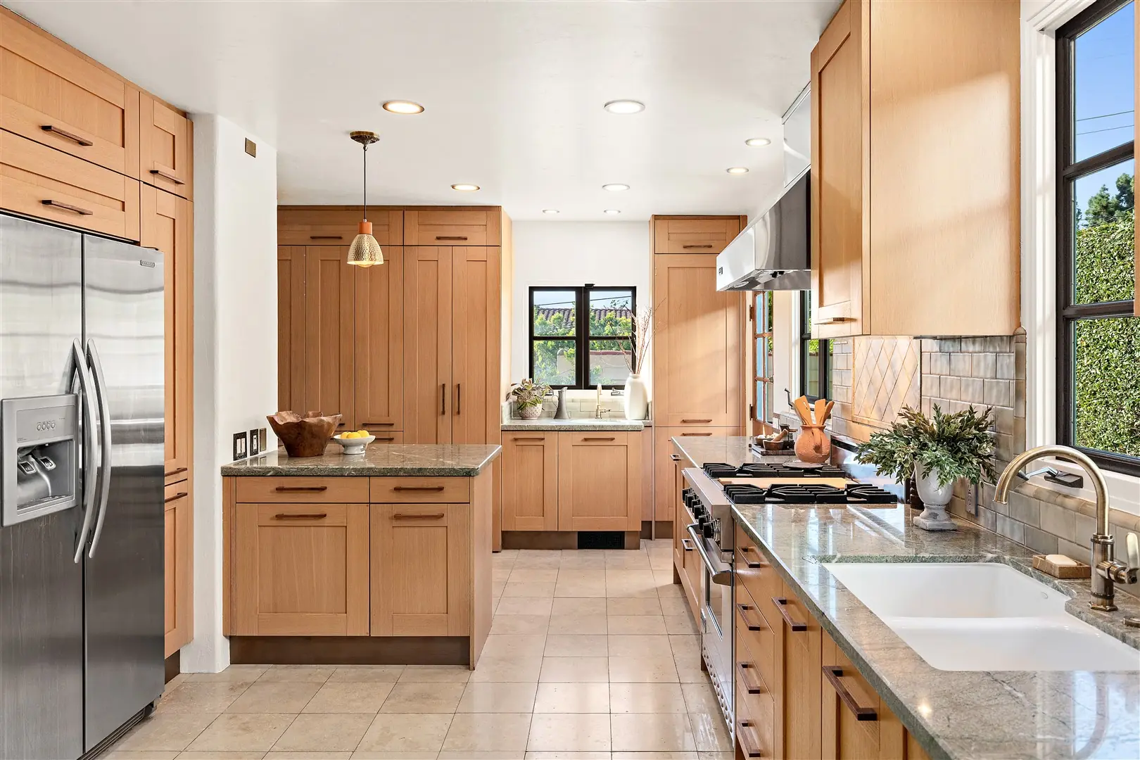 Kitchen cabinetry, stone surfaces, and restored windows at 1239 Geneva Street