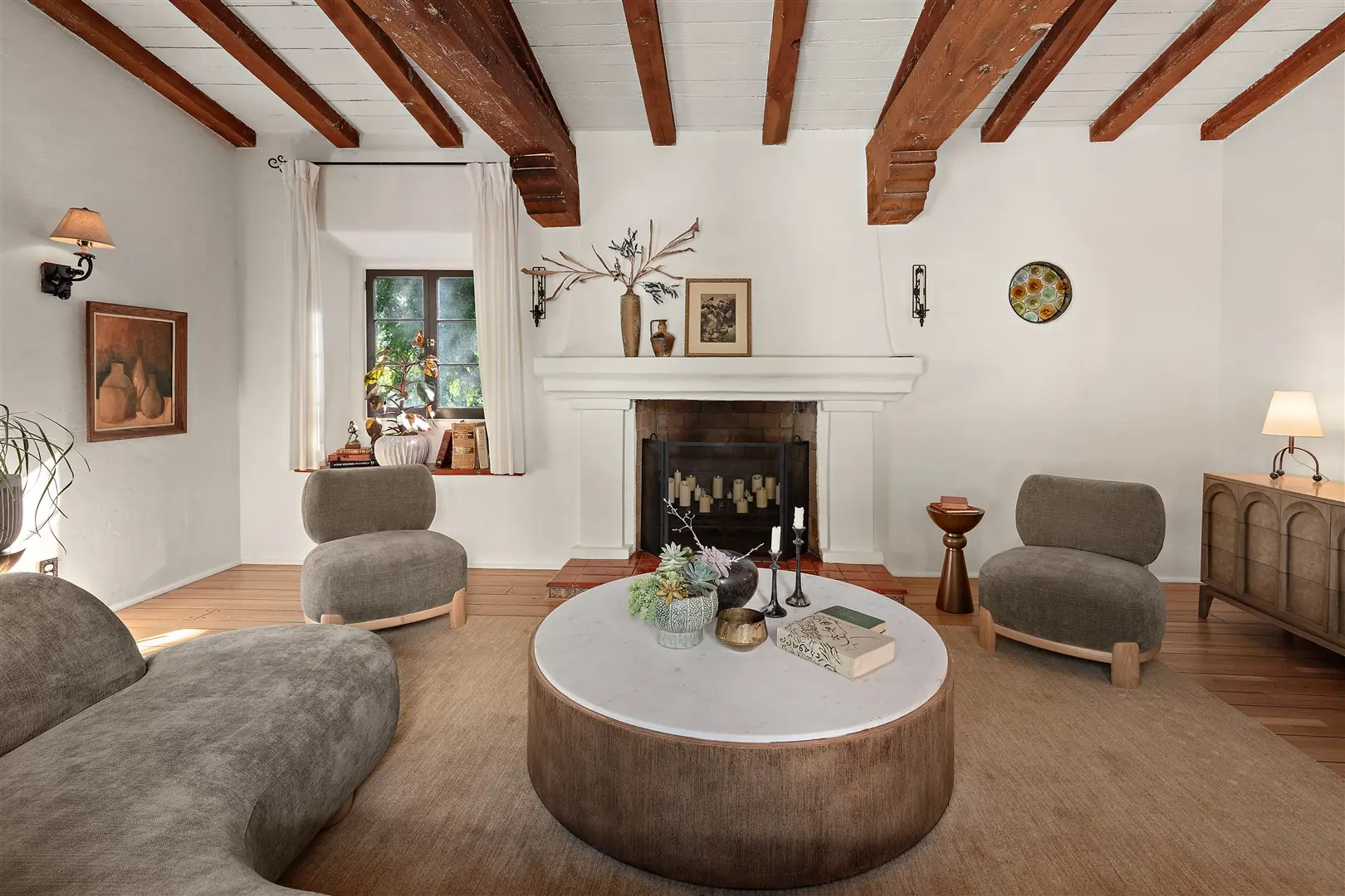 Living room with restored hardwood floors, plaster walls, and exposed beams at 1239 Geneva Street