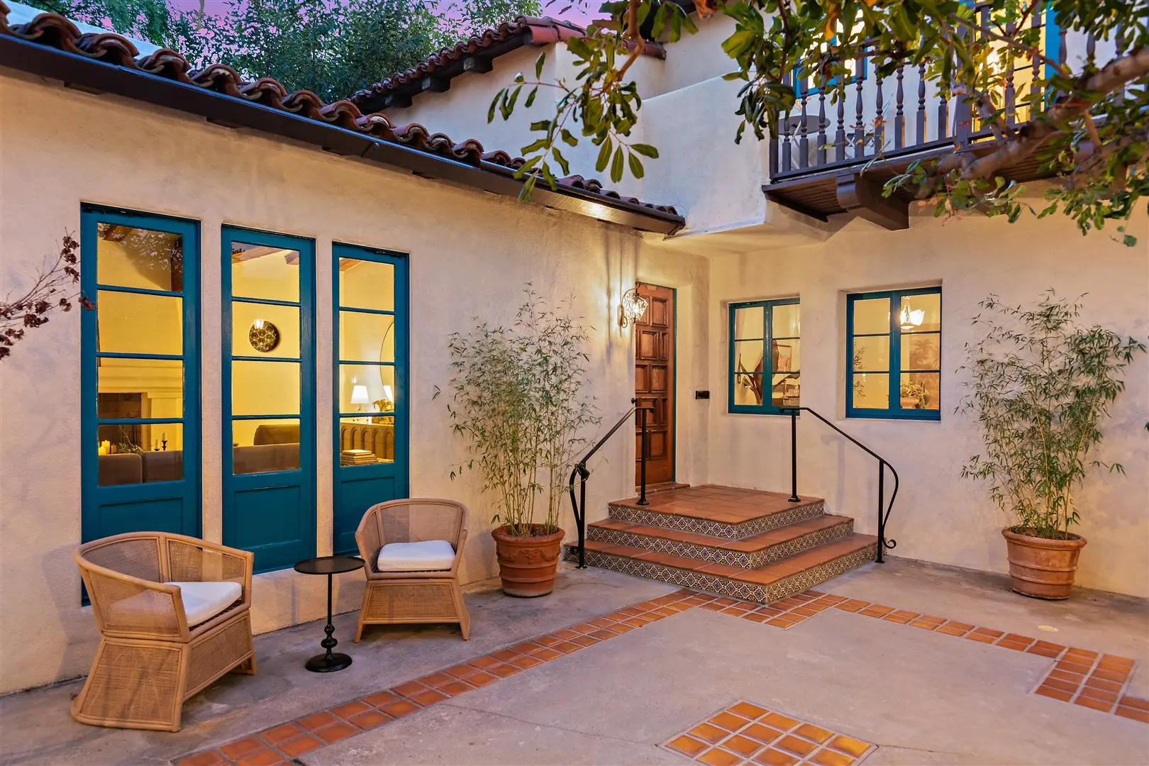 Evening courtyard with restored windows and French doors at 1239 Geneva Street