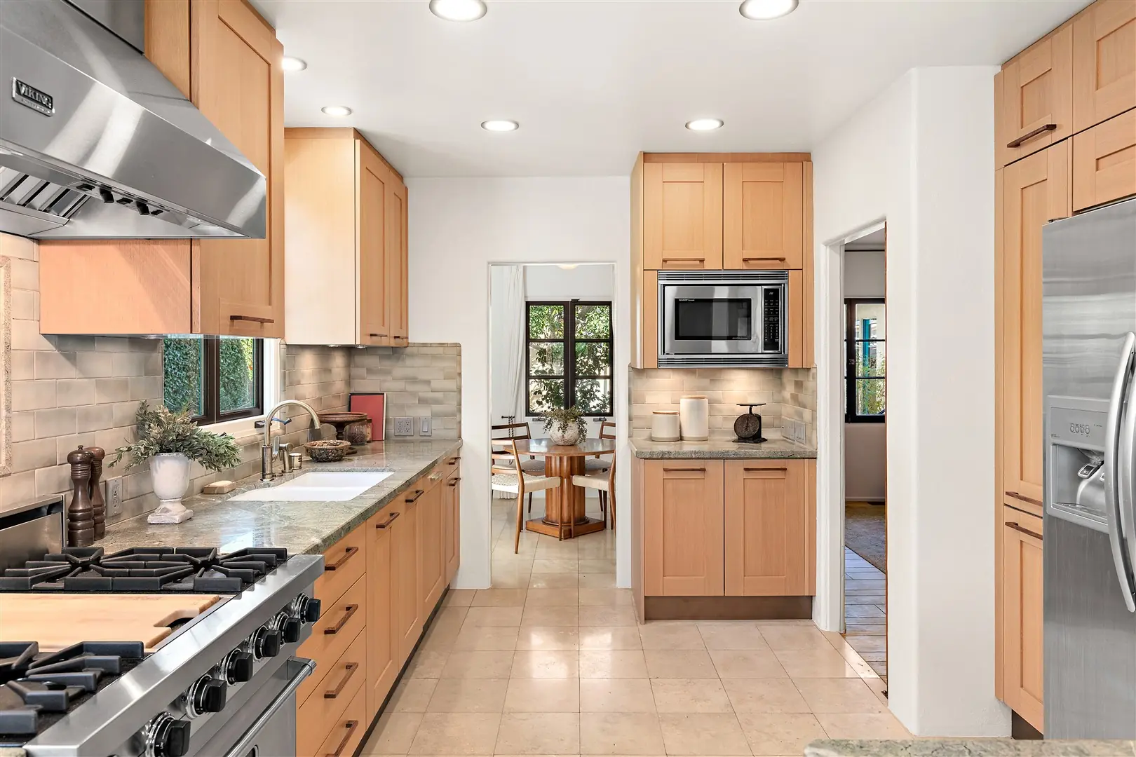 Kitchen cabinetry, stone surfaces, and restored windows at 1239 Geneva Street