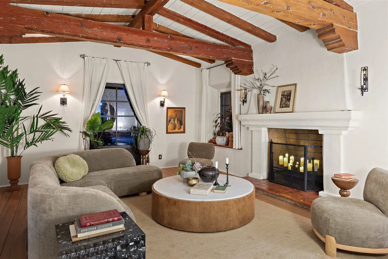 Living room with restored hardwood floors, plaster walls, and exposed beams at 1239 Geneva Street