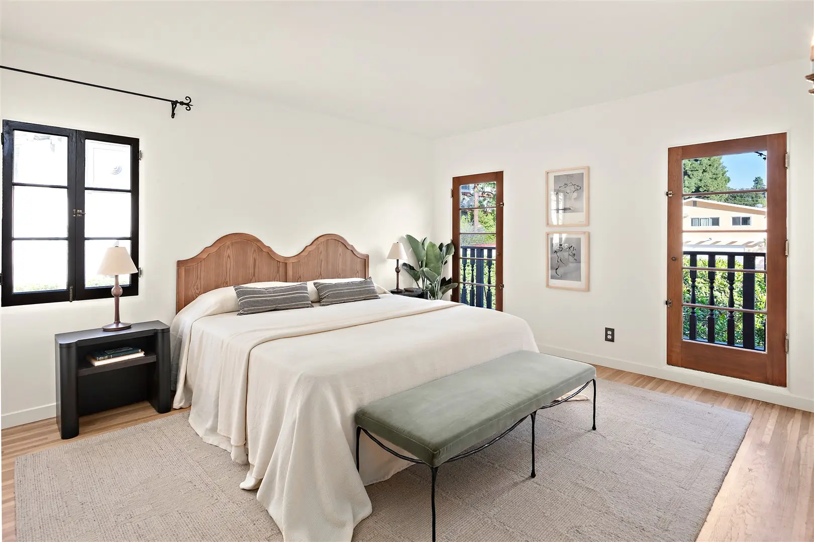 Bedroom with restored hardwood floors and dark-framed windows at 1239 Geneva Street