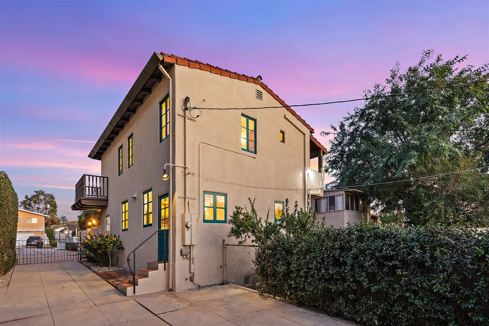 Rear exterior and balcony of 1239 Geneva Street at dusk