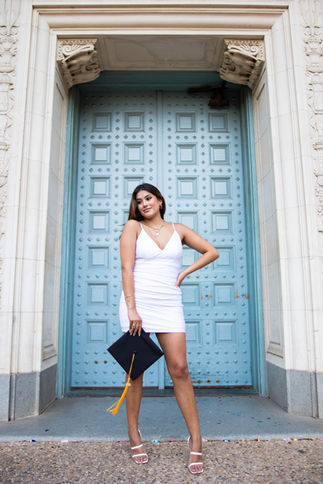 College senior smiling during an outdoor portrait session at the University of Texas in Austin