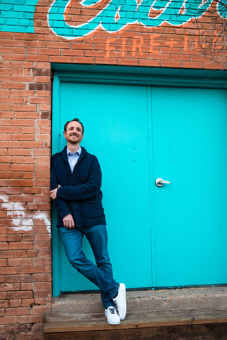 Man smiling during an outdoor portrait session in Dallas, Texas