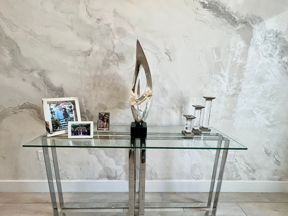 Luxury home entrance with artistic plaster finishes and modern decor.
