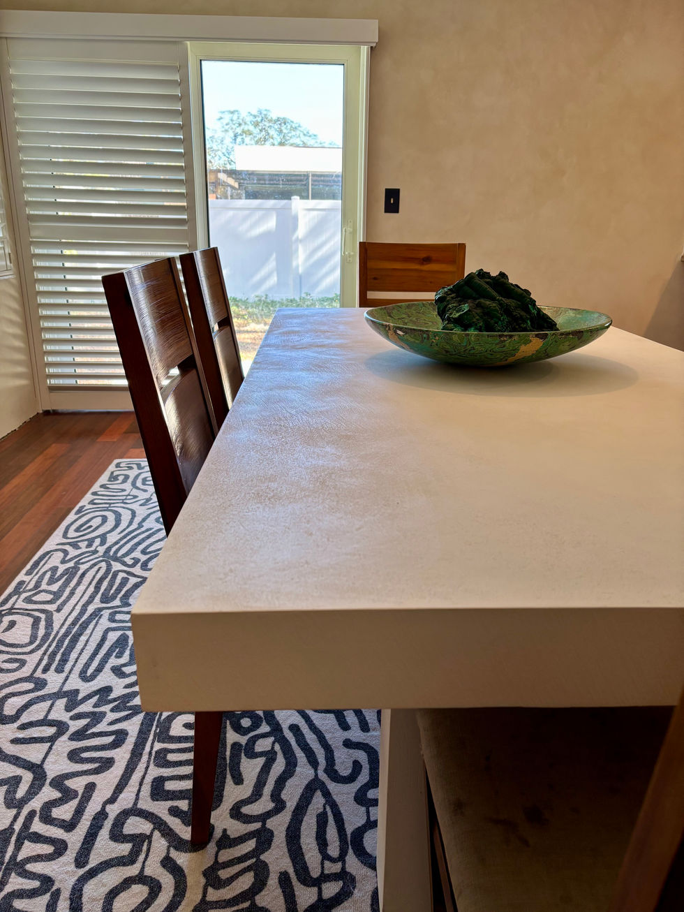 Luxury interior with an eco-conscious concrete dining table and natural decor.