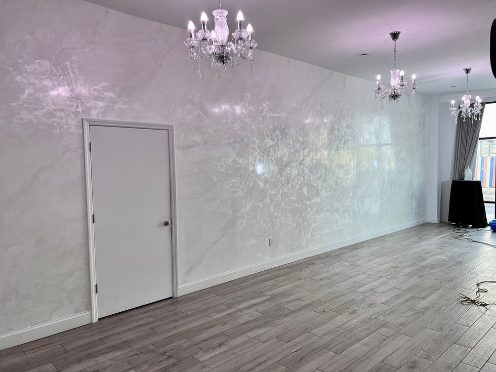 Contemporary interior with artistic Venetian plaster and chandeliers.