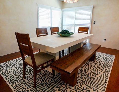 Minimalist concrete dining table with a sculptural, high-end design.