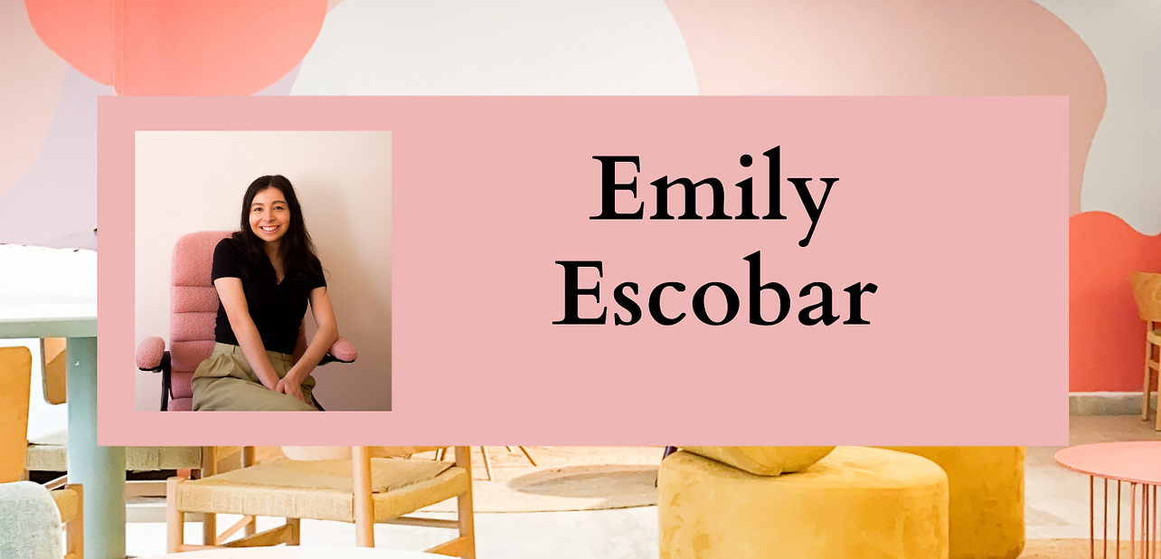 Emily sitting in a pink chair. 