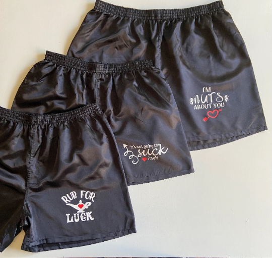 Thumbnail: Three black shorts with text: Run For Luck, I'm Nuts About You, and Suck.