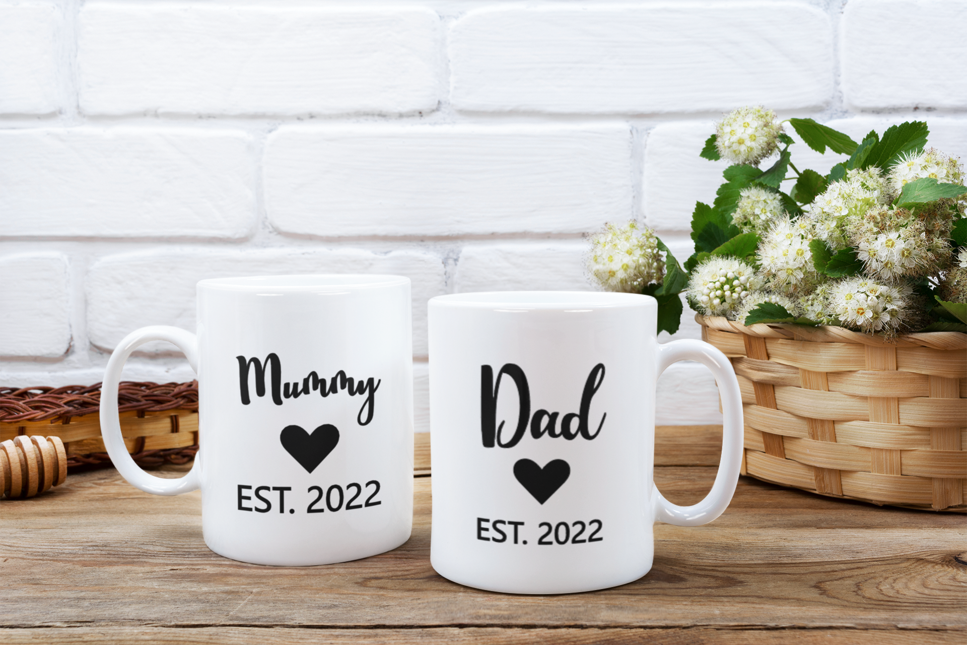 White mugs with "Mummy" and "Dad" text, "EST. 2022" on them.