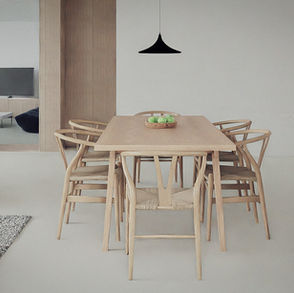 a wooden table with a bowl of apples on it
