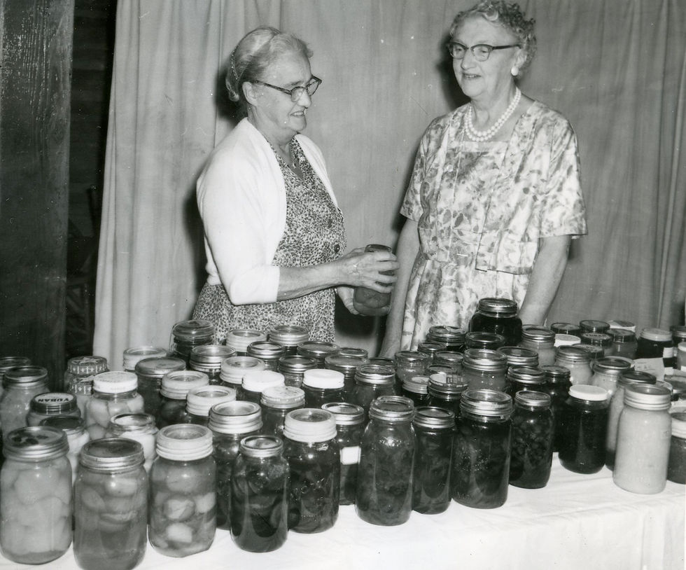 Mrs. Cecil Butler (l) and Mrs. Arnold Coulter check over a selection of preserves given to guests at a banquet at Chilliwack United Church, 22 September 1961. Photograph courtesy of the Chilliwack Progress Press (1999.029.013.113)