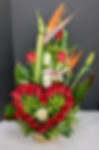 A heart with roses and more roses and other flowers bihind