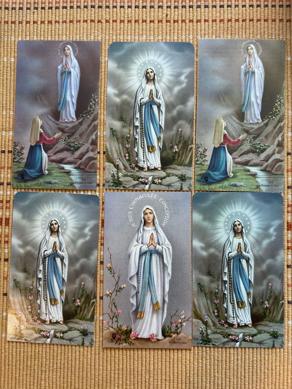 Our Lady of Lourdes vintage prayer cards here at the tattoo shop, note her rosary (she asked Saint Bernardette, to whom she appeared, to pray with her) and the rose imagery