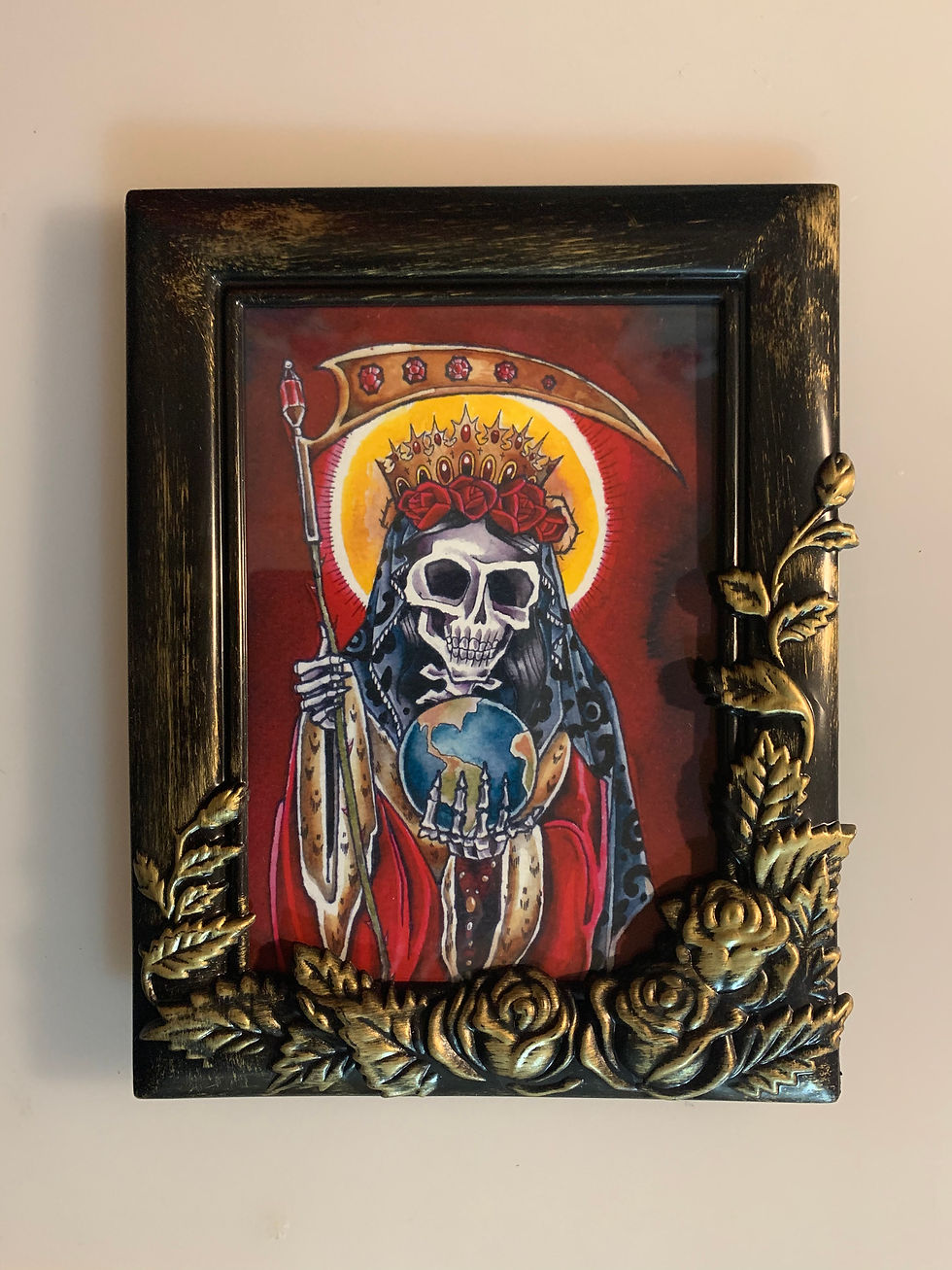A print of a painting of Santa Muerte made by the author