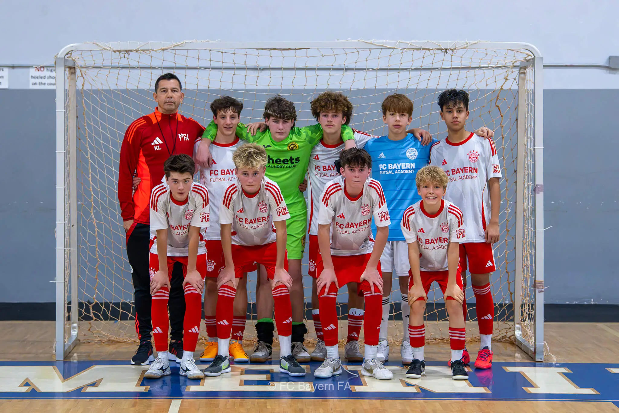 A group of kids from FC Bayern Futsal posing for a photo.